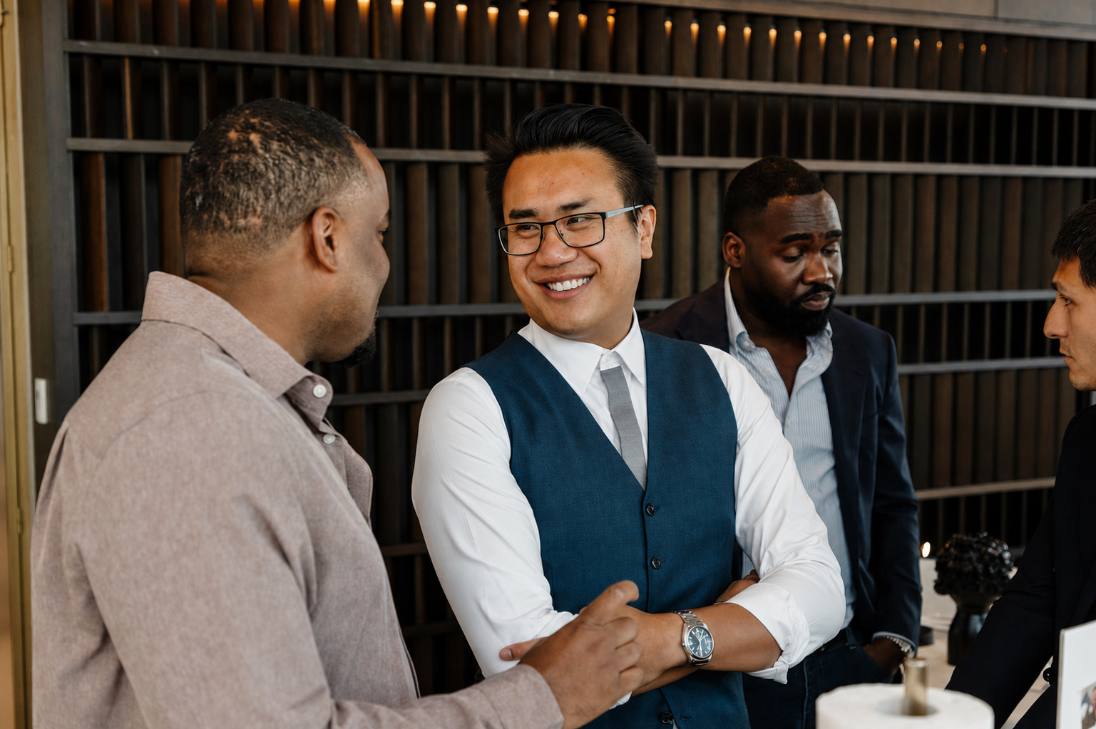 Suti in conversation with two guests at a professional networking event.